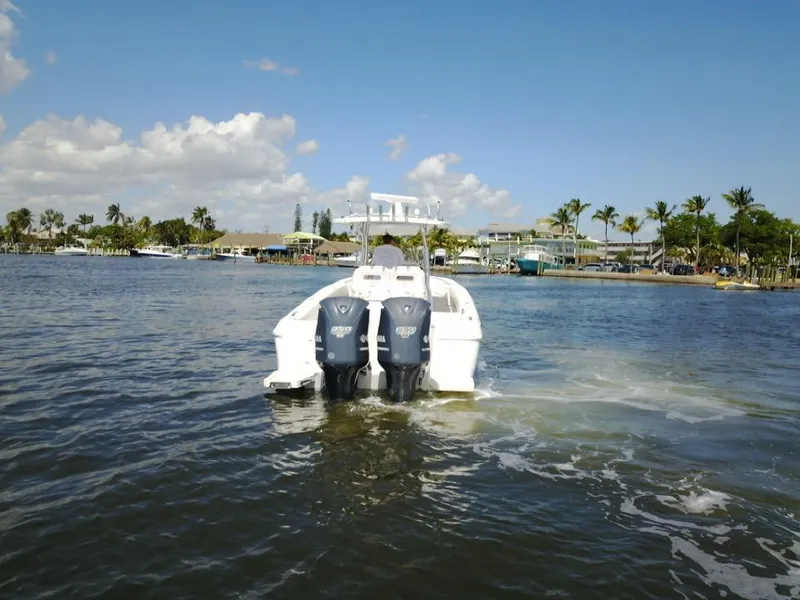 Slide: The Image of 2013 Intrepid 327 Center Console boat with twin outboard motors on the water. - 5