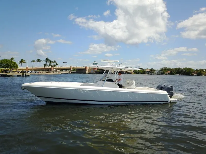 Slide: The Image of 2013 Intrepid 327 Center Console boat cruising on a sunny day. - 6
