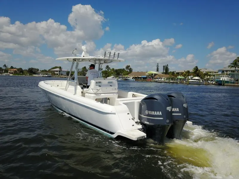 Slide: The Image of 2013 Intrepid 327 Center Console boat with twin Yamaha engines on the water. - 7
