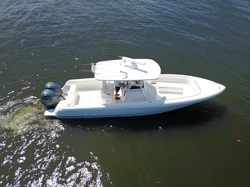 Slide: The Image of 2013 Intrepid 327 Center Console boat cruising on water. - 8