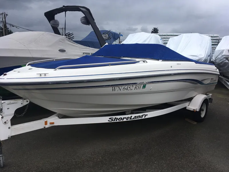 Slide: The Image of 1998 Chaparral 200 LE boat on ShoreLand'r trailer with blue cover. - 2