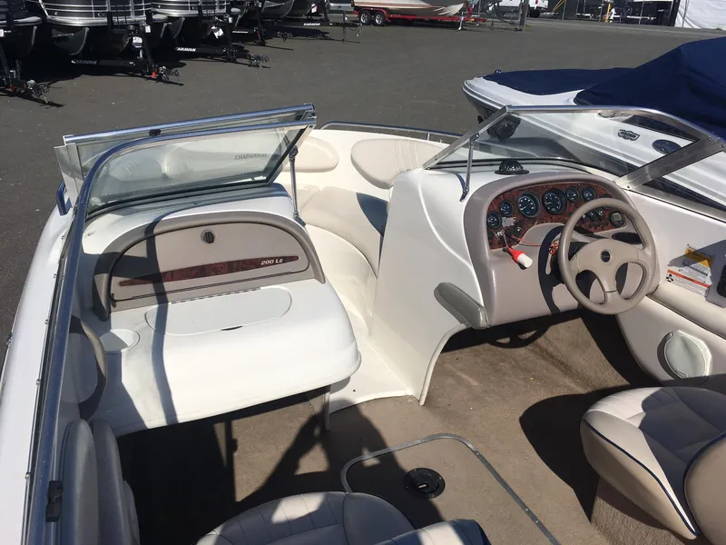 Slide: The Image of 1998 Chaparral 200 LE boat interior with steering wheel and seating. - 8