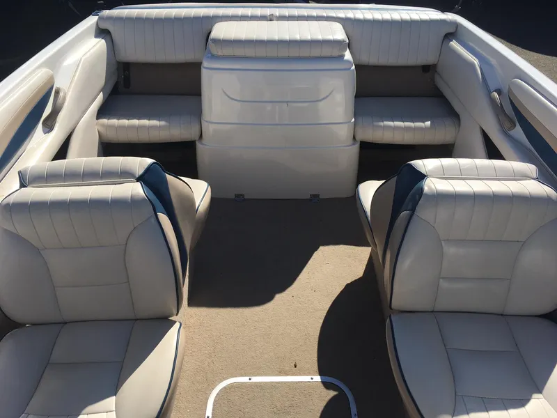 Slide: The Image of 1998 Chaparral 200 LE boat interior with white leather seats and beige carpet. - 9