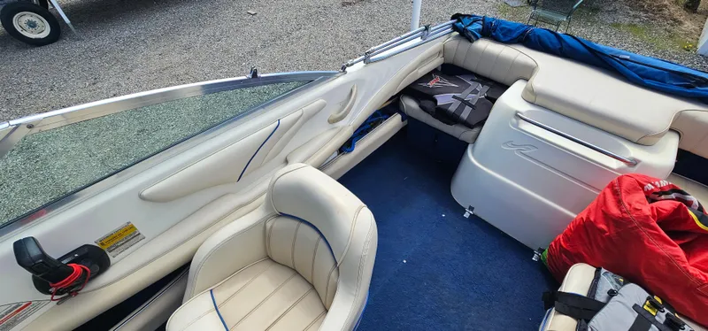 Slide: The Image of Interior of a 1995 Sea Ray 200 Signature boat with white seating and blue carpet. - 10