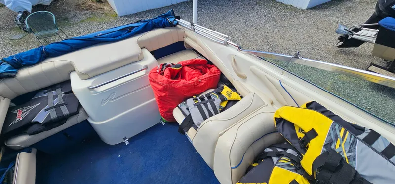Slide: The Image of Interior of a 1995 Sea Ray 200 Signature boat with life jackets and gear. - 11