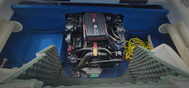 Slide: The Image of 1995 Sea Ray 200 Signature boat engine compartment with blue interior and yellow rope. - 12