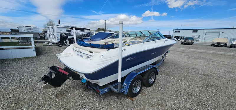 Slide: The Image of 1995 Sea Ray 200 Signature boat on a trailer in a gravel lot. - 3