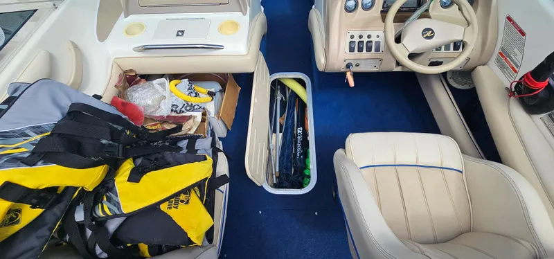 Slide: The Image of Interior of a 1995 Sea Ray 200 Signature boat with storage compartments and life jackets. - 7