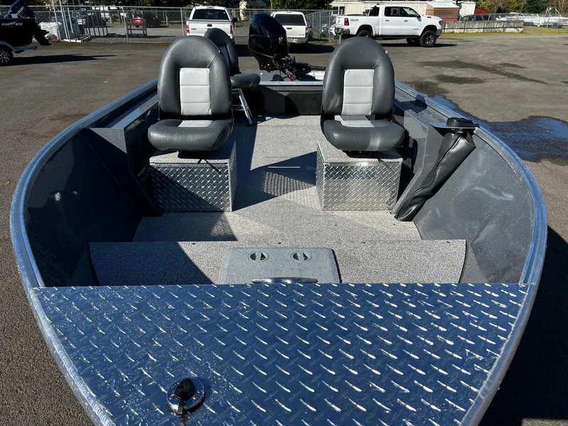 Slide: The Image of 2024 Fish Rite Angler 18 boat interior with two seats and diamond plate flooring. - 7