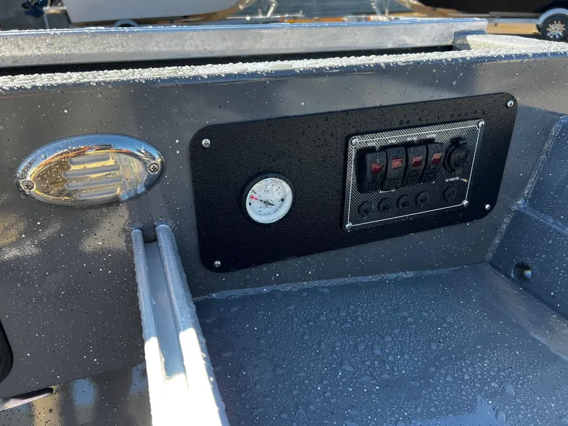 Slide: The Image of Control panel of the 2024 Fish Rite Angler 18 boat with switches and gauge. - 9