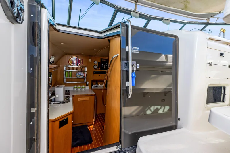 Slide: The Image of Interior view of 1999 Tiara Yachts 4000 Express, showcasing kitchen and living area. - 10