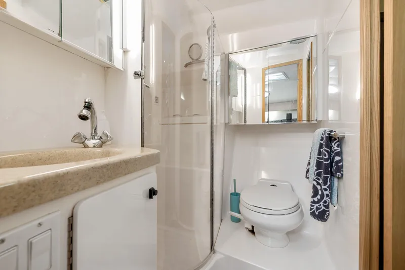 Slide: The Image of 1999 Tiara Yachts 4000 Express bathroom with sink, shower, and toilet. - 16