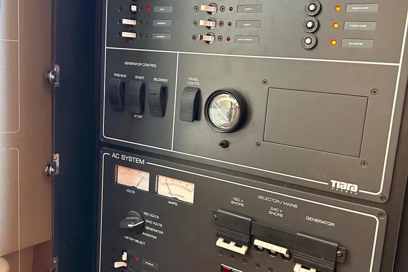 Slide: The Image of Control panel of a 1999 Tiara Yachts 4000 Express, featuring generator and AC system controls. - 19