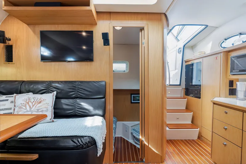 Slide: The Image of 1999 Tiara Yachts 4000 Express interior with modern amenities and wooden finishes. - 5