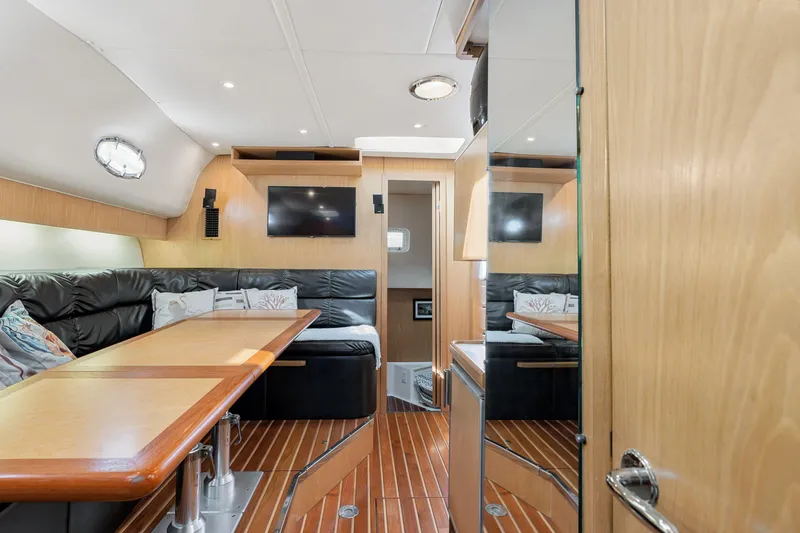 Slide: The Image of 1999 Tiara Yachts 4000 Express interior with wood finishes and leather seating. - 8