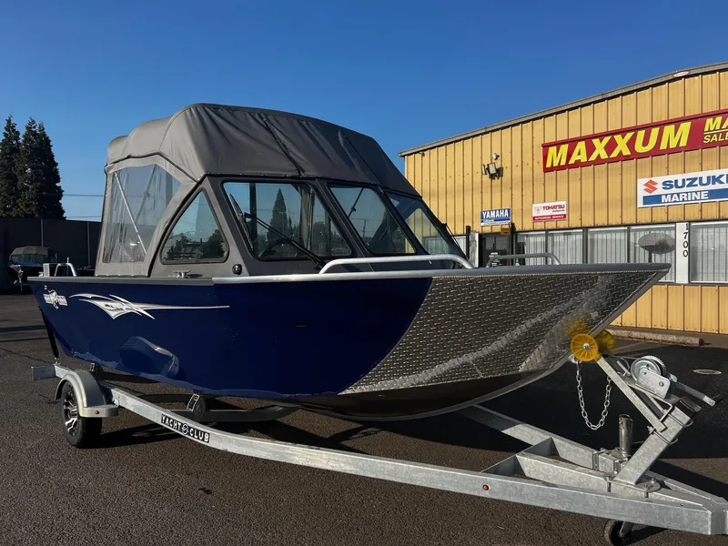 Slide: The Image of 2024 Fish Rite 180 Sportsman boat on trailer, parked outside Maxxum Marine dealership. - 1