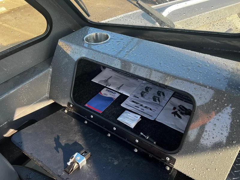 Slide: The Image of 2024 Fish Rite 180 Sportsman interior with storage compartment and cup holder. - 11