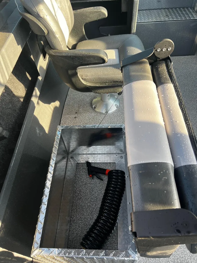 Slide: The Image of 2024 Fish Rite 180 Sportsman boat interior with seating and storage compartment. - 12