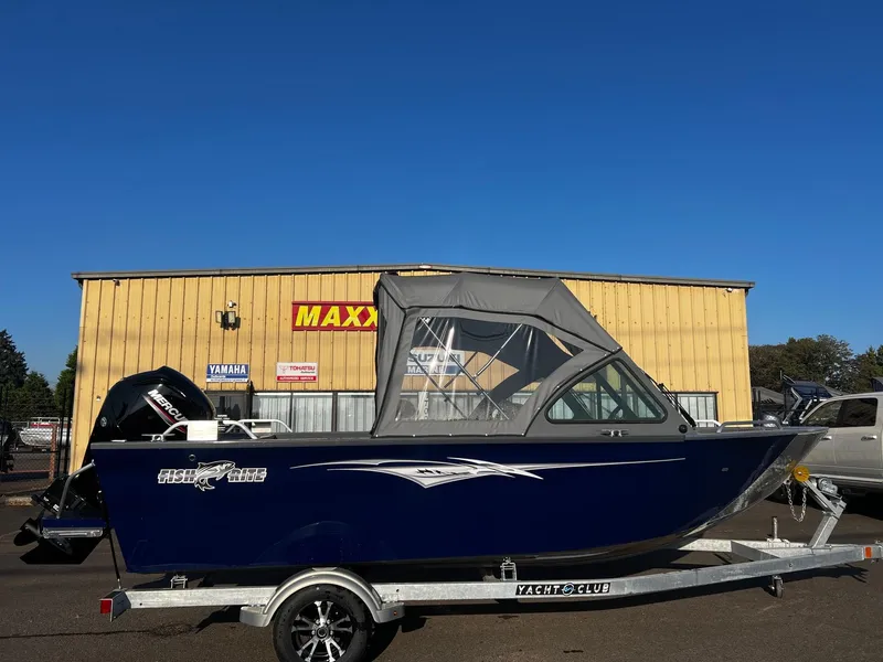 Slide: The Image of 2024 Fish Rite 180 Sportsman boat on trailer, parked outside dealership. - 2