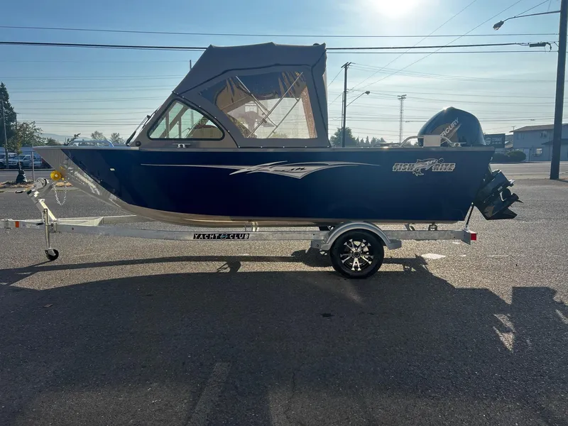 Slide: The Image of 2024 Fish Rite 180 Sportsman boat on trailer, side view, blue exterior. - 5