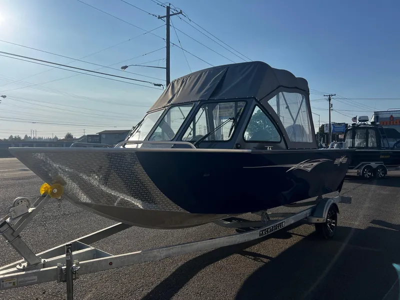 Slide: The Image of 2024 Fish Rite 180 Sportsman boat on trailer, parked outdoors. - 6