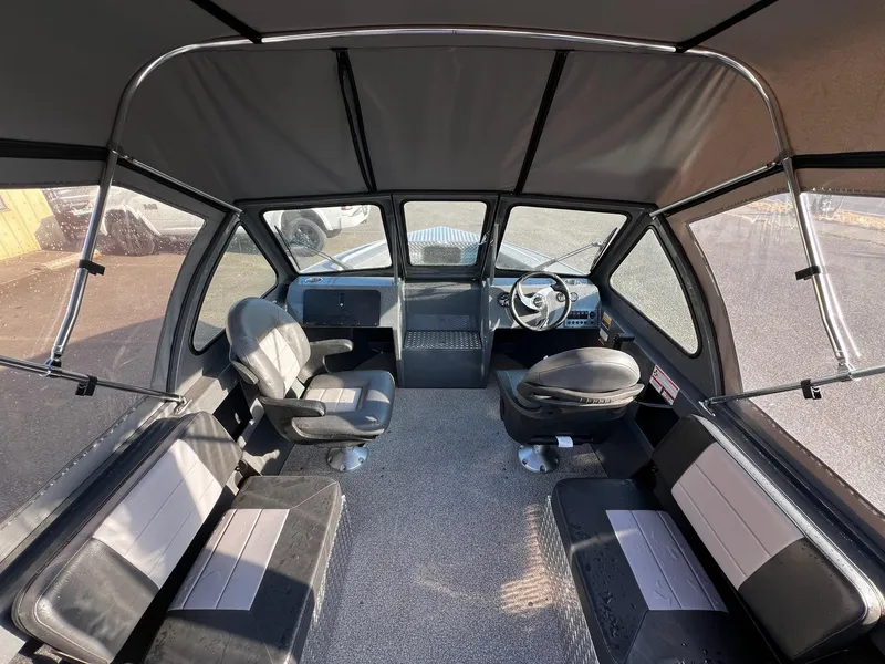 Slide: The Image of Interior of 2024 Fish Rite 180 Sportsman boat with seating and steering wheel. - 7