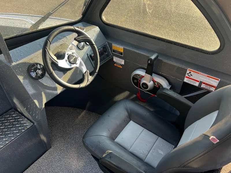 Slide: The Image of 2024 Fish Rite 180 Sportsman boat interior with steering wheel and seat. - 9