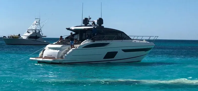 The Image of 2018 Princess V58 yacht on clear blue water with another boat in the background. - 0
