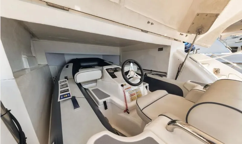 Slide: The Image of Interior view of a 2018 Princess V58 yacht cockpit, featuring modern steering and controls. - 15