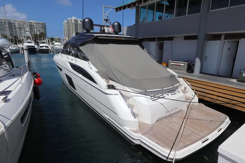 Slide: The Image of 2018 Princess V58 yacht docked at marina, covered, with modern design and sleek lines. - 16