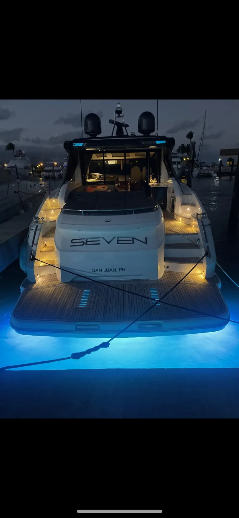Slide: The Image of 2018 Princess V58 yacht with illuminated deck and underwater lights at night. - 17