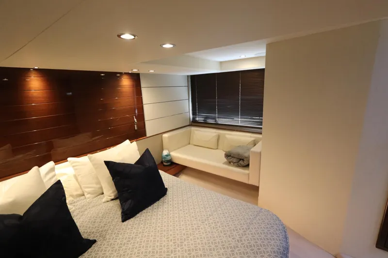 Slide: The Image of Luxurious cabin interior of 2018 Princess V58 yacht with cozy bed and seating area. - 8