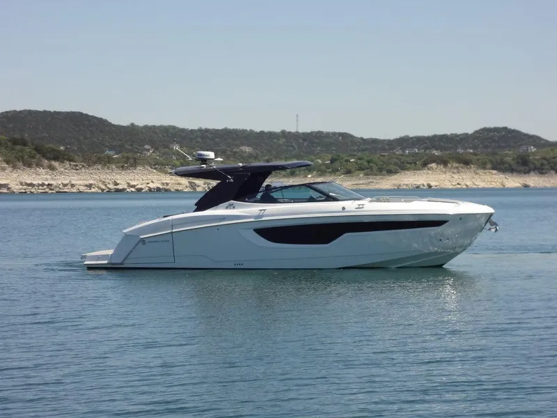Slide: The Image of 2021 Cruisers Yachts 38 GLS I/O on calm water with scenic background. - 12