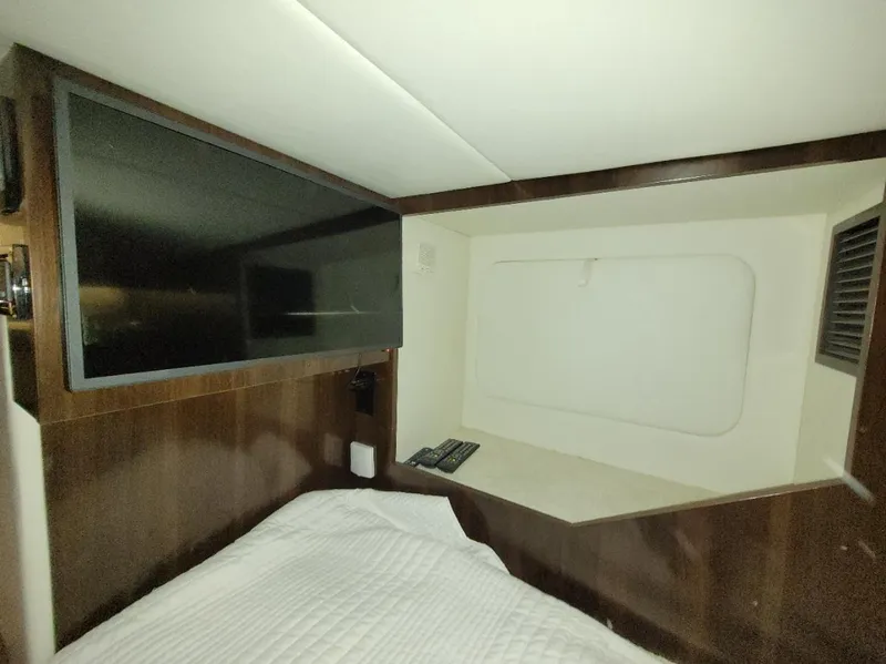 Slide: The Image of 2021 Cruisers Yachts 38 GLS I/O cabin interior with TV and bed. - 21