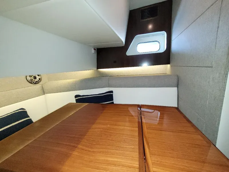 Slide: The Image of Interior cabin of 2021 Cruisers Yachts 38 GLS I/O with wooden table and cushioned seating. - 23