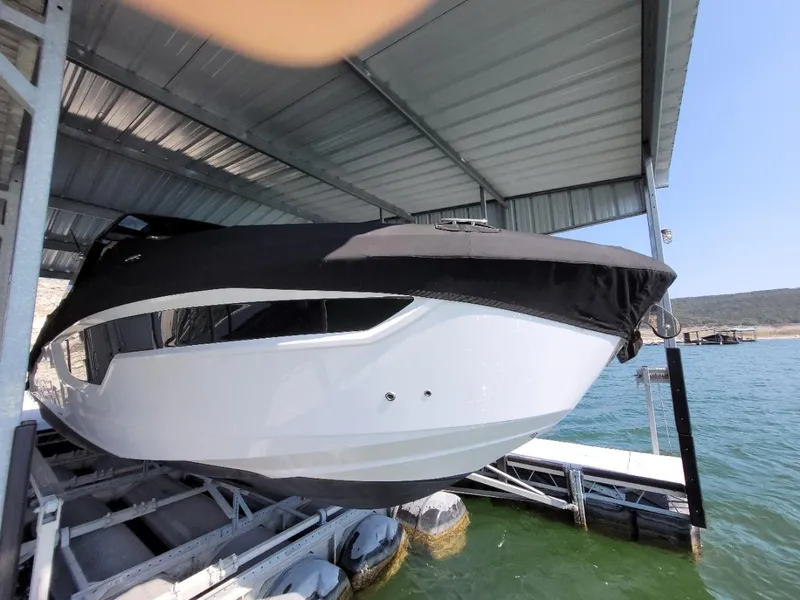 Slide: The Image of 2021 Cruisers Yachts 38 GLS I/O docked under a metal canopy. - 30
