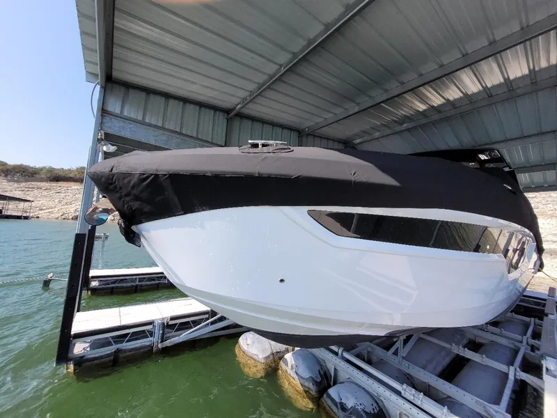 Slide: The Image of 2021 Cruisers Yachts 38 GLS I/O boat docked under a covered marina. - 31