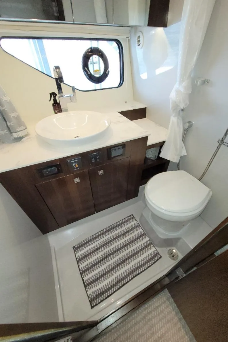 Slide: The Image of 2021 Cruisers Yachts 38 GLS I/O bathroom with modern sink and toilet. - 39
