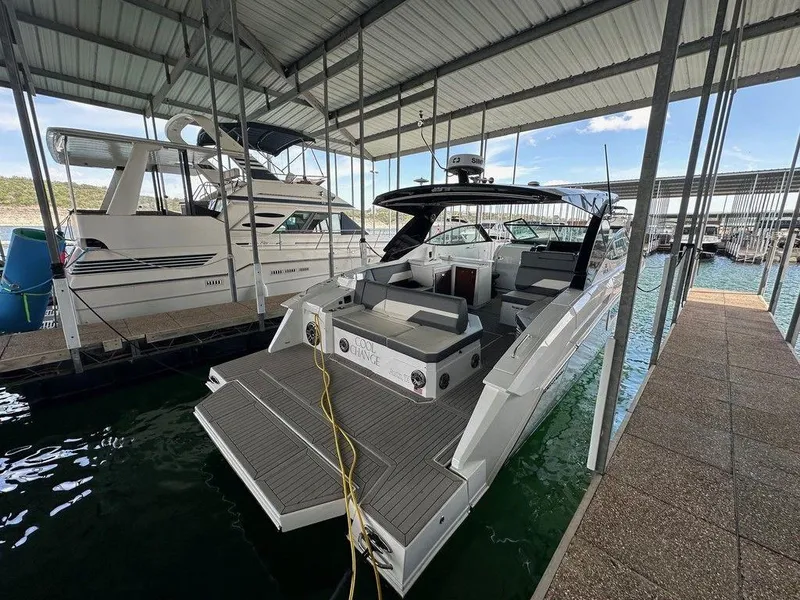Slide: The Image of 2021 Cruisers Yachts 38 GLS I/O docked in a covered marina. - 4
