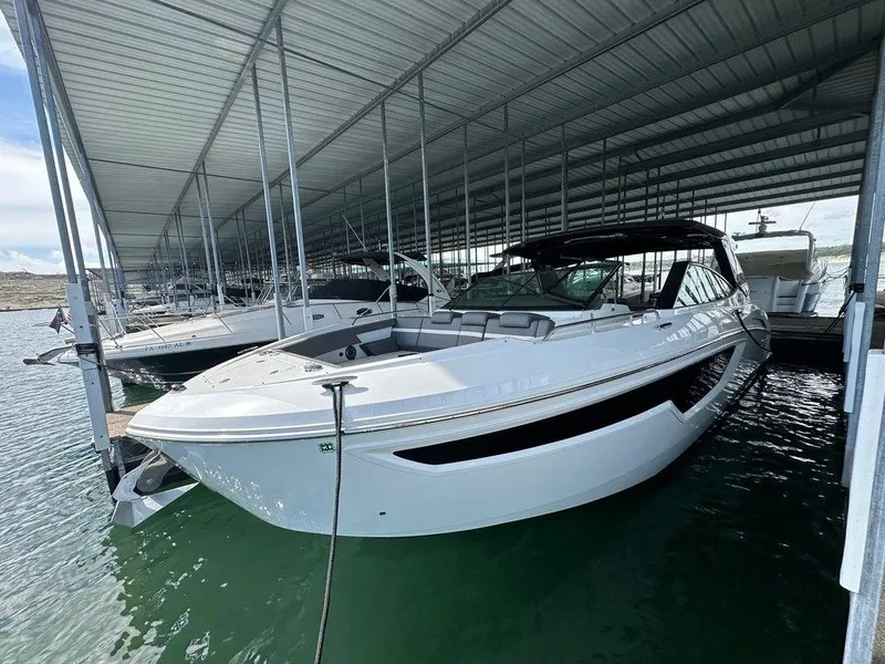 Slide: The Image of 2021 Cruisers Yachts 38 GLS I/O docked in a covered marina. - 5