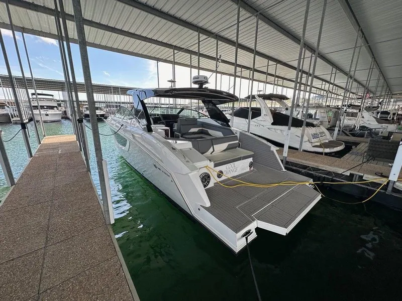 Slide: The Image of 2021 Cruisers Yachts 38 GLS I/O docked in a marina under a covered slip. - 8