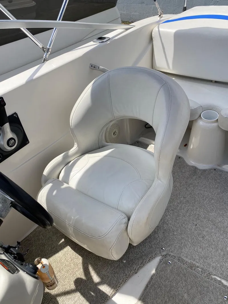 Slide: The Image of 2008 Glastron 175 MX boat interior with white captain's chair and steering wheel. - 11