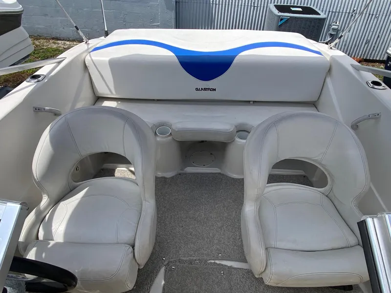 Slide: The Image of 2008 Glastron 175 MX boat interior with white seats and blue accents. - 13