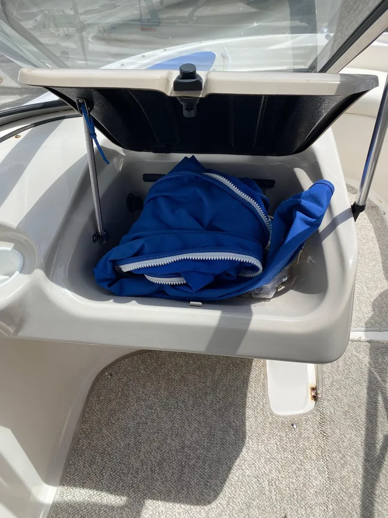 Slide: The Image of Storage compartment of a 2008 Glastron 175 MX boat with blue cover inside. - 19