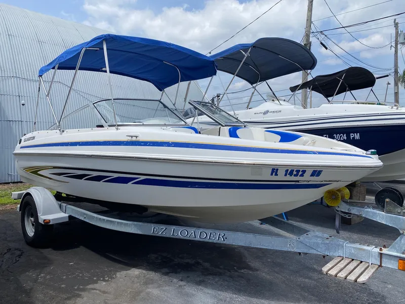 Slide: The Image of 2008 Glastron 175 MX boat with blue accents on EZ Loader trailer. - 3