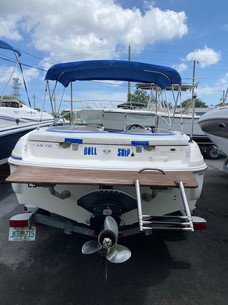 Slide: The Image of 2008 Glastron 175 MX boat with blue canopy and rear ladder. - 4