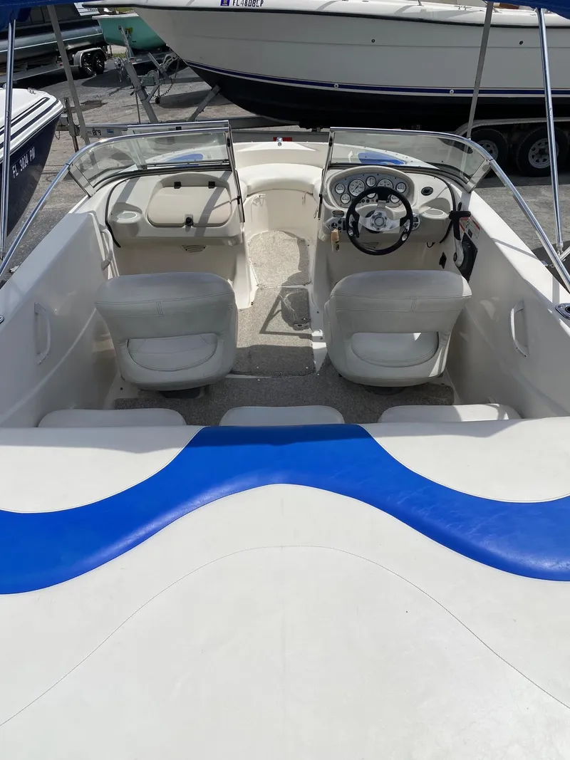 Slide: The Image of 2008 Glastron 175 MX boat interior with white seats and blue accents. - 5