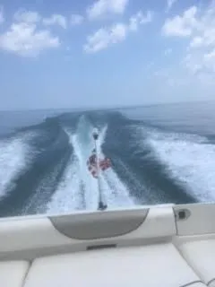 Slide: The Image of 2007 Sea Ray 215 Weekender cruising on open water under a clear sky. - 13