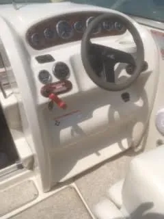 Slide: The Image of 2007 Sea Ray 215 Weekender boat dashboard with steering wheel and instrument panel. - 4