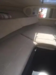 Slide: The Image of Interior cabin of 2007 Sea Ray 215 Weekender boat with beige seating. - 7